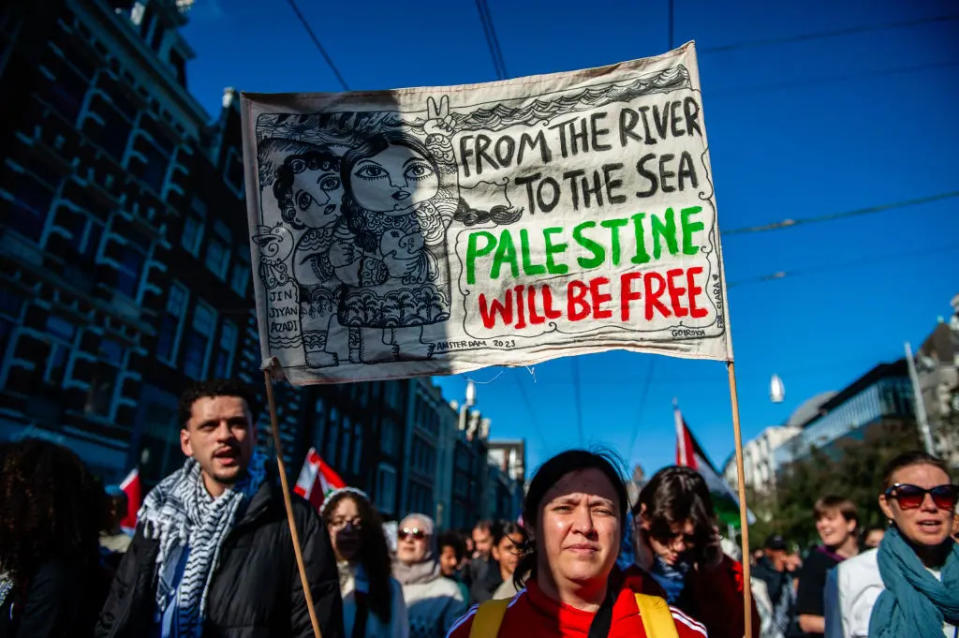 Anti-Israeli protester in Amsterdam, Netherlands holds up a poster with the slogan ‘From the River to the Sea, Palestine will be Free.’ The ADL has called the slogan antisemitic. Amsterdam, October 5, 2024.