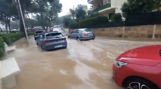 Some motorists attempted to drive through the floodwaters in Majorca, while others abandoned their vehicles as torrents of water poured through the street