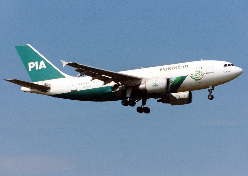 A Pakistan International Airlines Airbus A310-308 in flight against blue skies. 