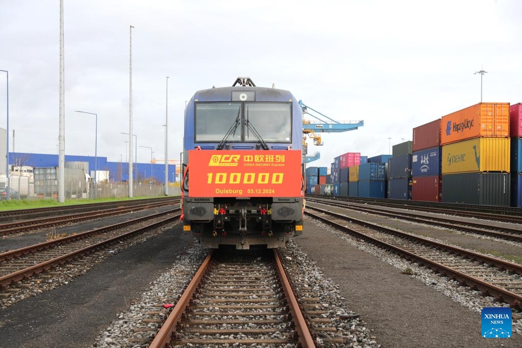 This photo taken on Dec. 3, 2024 shows the 100,000th China-Europe freight train at Duisburg Intermodal Terminal (DIT) in Duisburg, Germany. The 100,000th China-Europe freight train arrived in Duisburg, Germany on Tuesday morning, marking a historic milestone for this rail link. The train, X8083, which had departed from Chongqing, China, arrived at Duisburg's terminal at 9:10 a.m. local time, carrying electronics, industrial parts, and household appliances. The train's cargo was quickly unloaded for distribution to various destinations across Europe. (Photo: Xinhua)