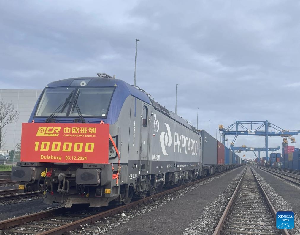 This photo taken on Dec. 3, 2024 shows the 100,000th China-Europe freight train at Duisburg Intermodal Terminal (DIT) in Duisburg, Germany. The 100,000th China-Europe freight train arrived in Duisburg, Germany on Tuesday morning, marking a historic milestone for this rail link. The train, X8083, which had departed from Chongqing, China, arrived at Duisburg's terminal at 9:10 a.m. local time, carrying electronics, industrial parts, and household appliances. The train's cargo was quickly unloaded for distribution to various destinations across Europe. (Photo: Xinhua)