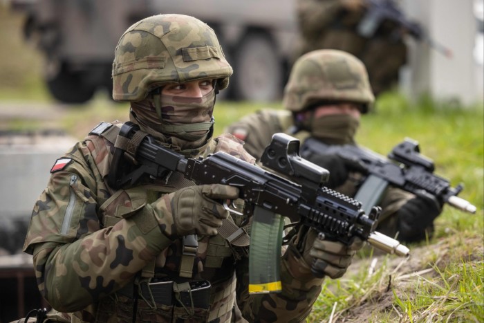 Polish soldiers take up positions during military drills of Polish and Nato soldiers near the Vistula Spit canal, near Krynica Morska, northern Poland