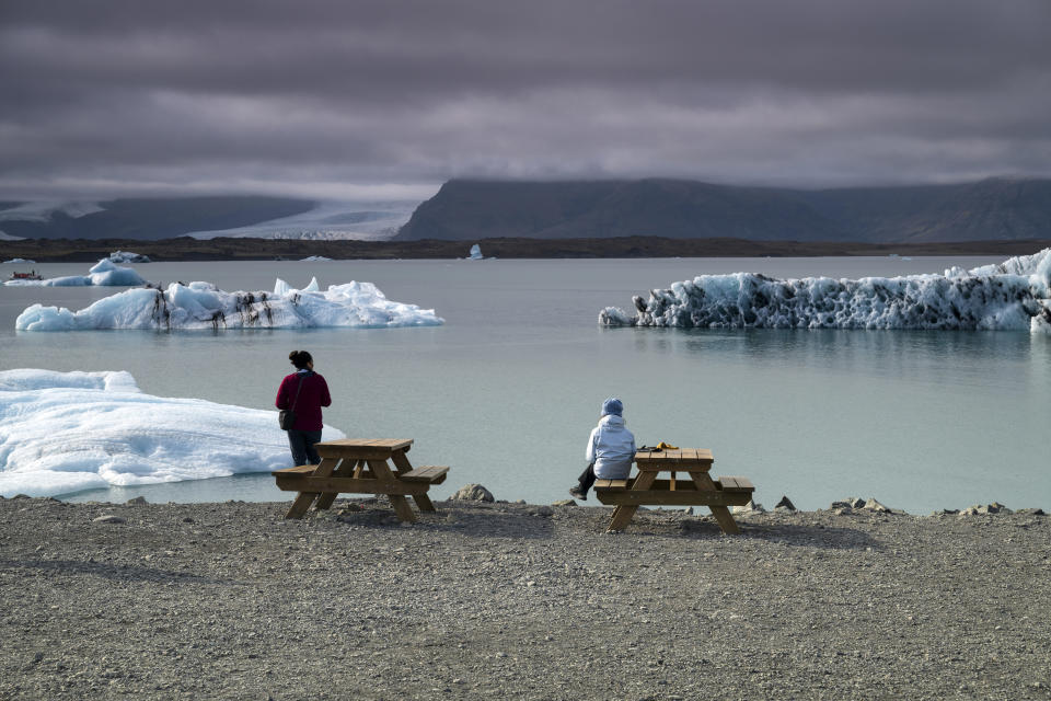 Two women at Jökulsárlón glacier lagoon, Vatnajökull National Park, Eastern region, Iceland. 21 sept, 2024