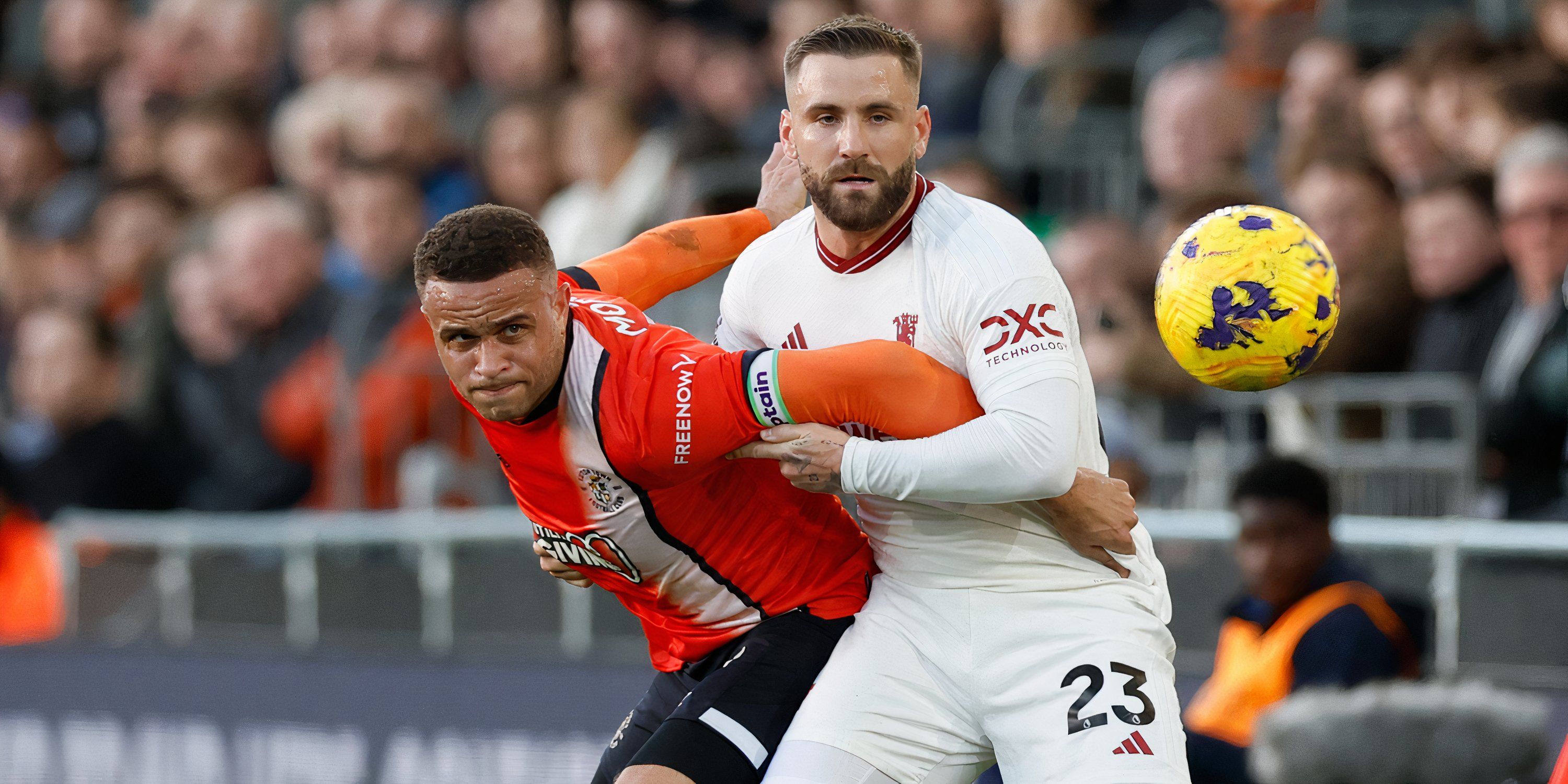 Manchester United left-back Luke Shaw and Luton Town striker Carlton Morris battling for possession