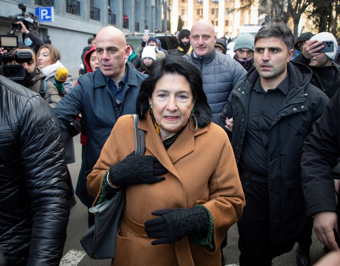 Outgoing President Salome Zourabichvili walks outside the parliament building as deputies vote to elect a new president.