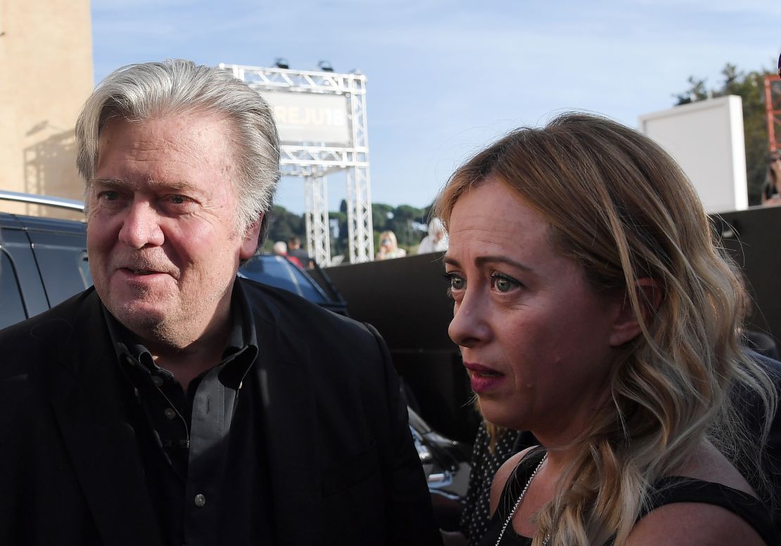 Former White House Chief Strategist Steve Bannon (L) arrives with Giorgia Meloni (R) to attend a congress of the party in Rome on September 22, 2018.