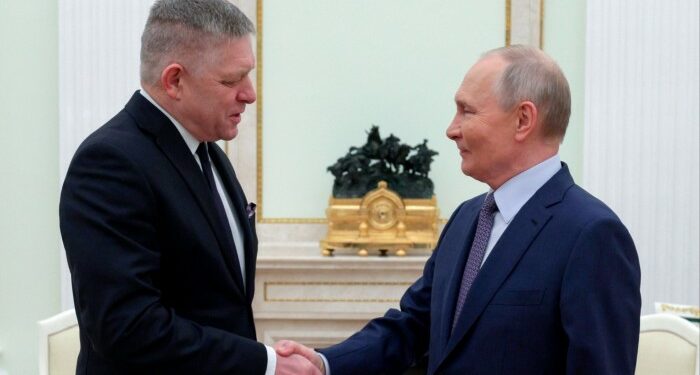 Vladimir Putin, right, and Robert Fico greet each other at the Kremlin