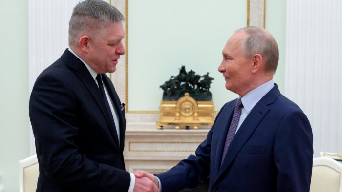 Vladimir Putin, right, and Robert Fico greet each other at the Kremlin