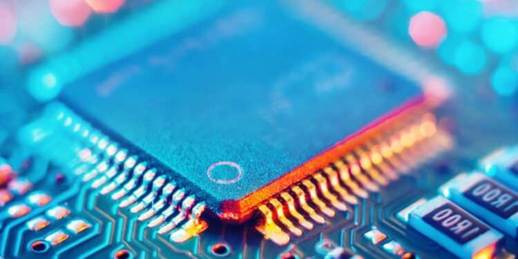 A close-up of a computer microchip on an electronic circuit board.