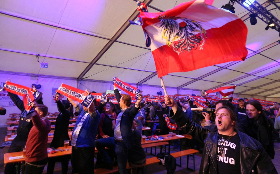 Supporters wave a flag during the local elections in Vienna for the FPO