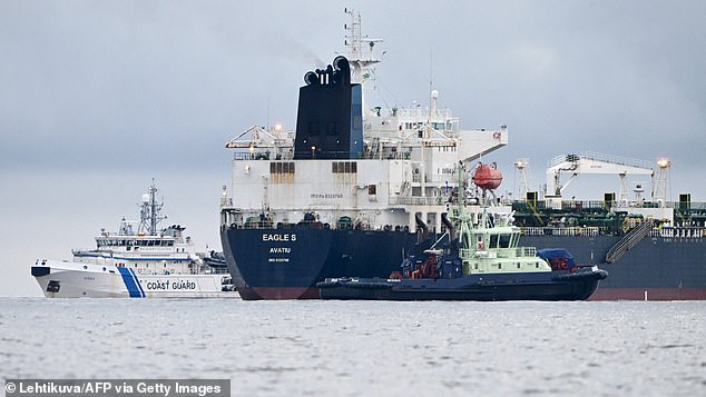 A photo taken on December 28, 2024 off Porkkalanniemi, Kirkkonummi, in the Gulf of Finland, shows oil tanker Eagle S (C), which flies under the flag of the Cook Islands, next to Finnish border guard ship Uisko (L) and tugboat Ukko (front R)