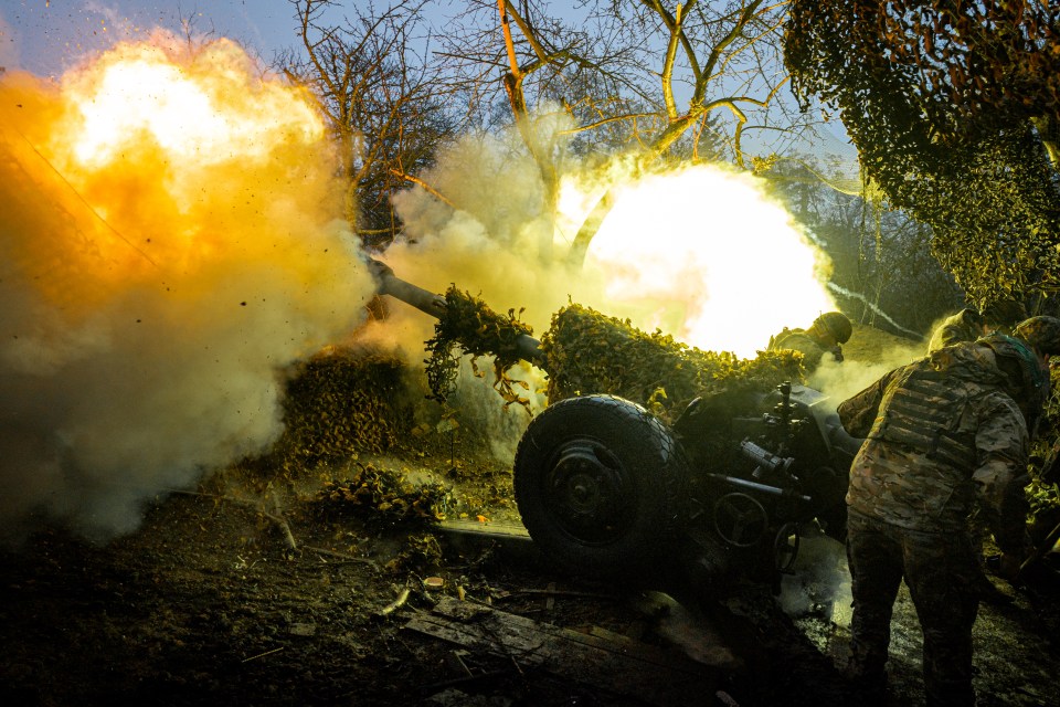 Ukrainian soldiers firing a howitzer.