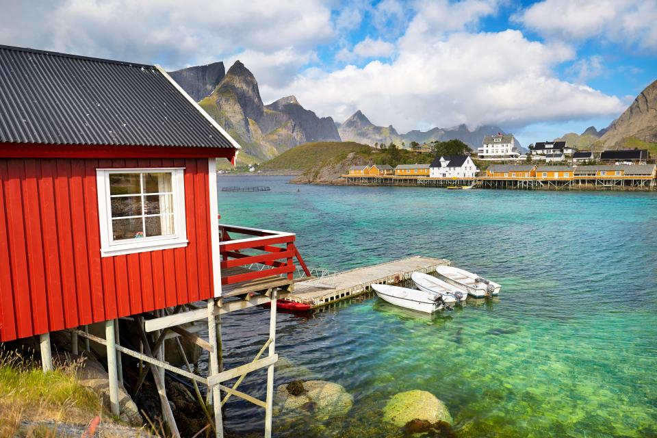 Red fishing hut on stilts in Lofoten Islands, Norway.