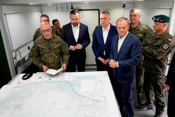 Poland’s prime minister Donald Tusk with officials