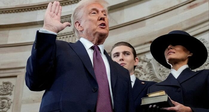 Donald Trump is sworn in as the 47th President of the United States as Melania Trump holds the Bible