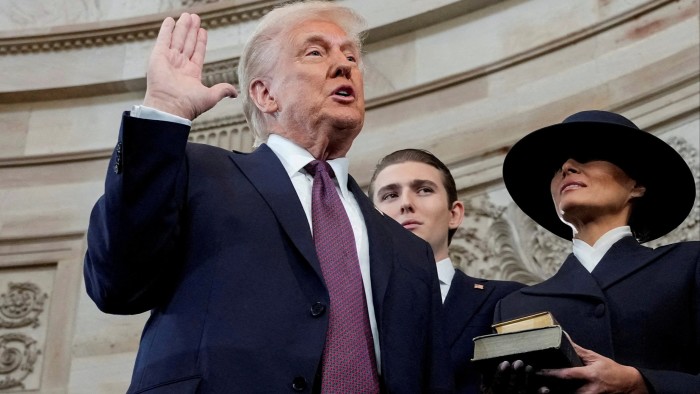 Donald Trump is sworn in as the 47th President of the United States as Melania Trump holds the Bible