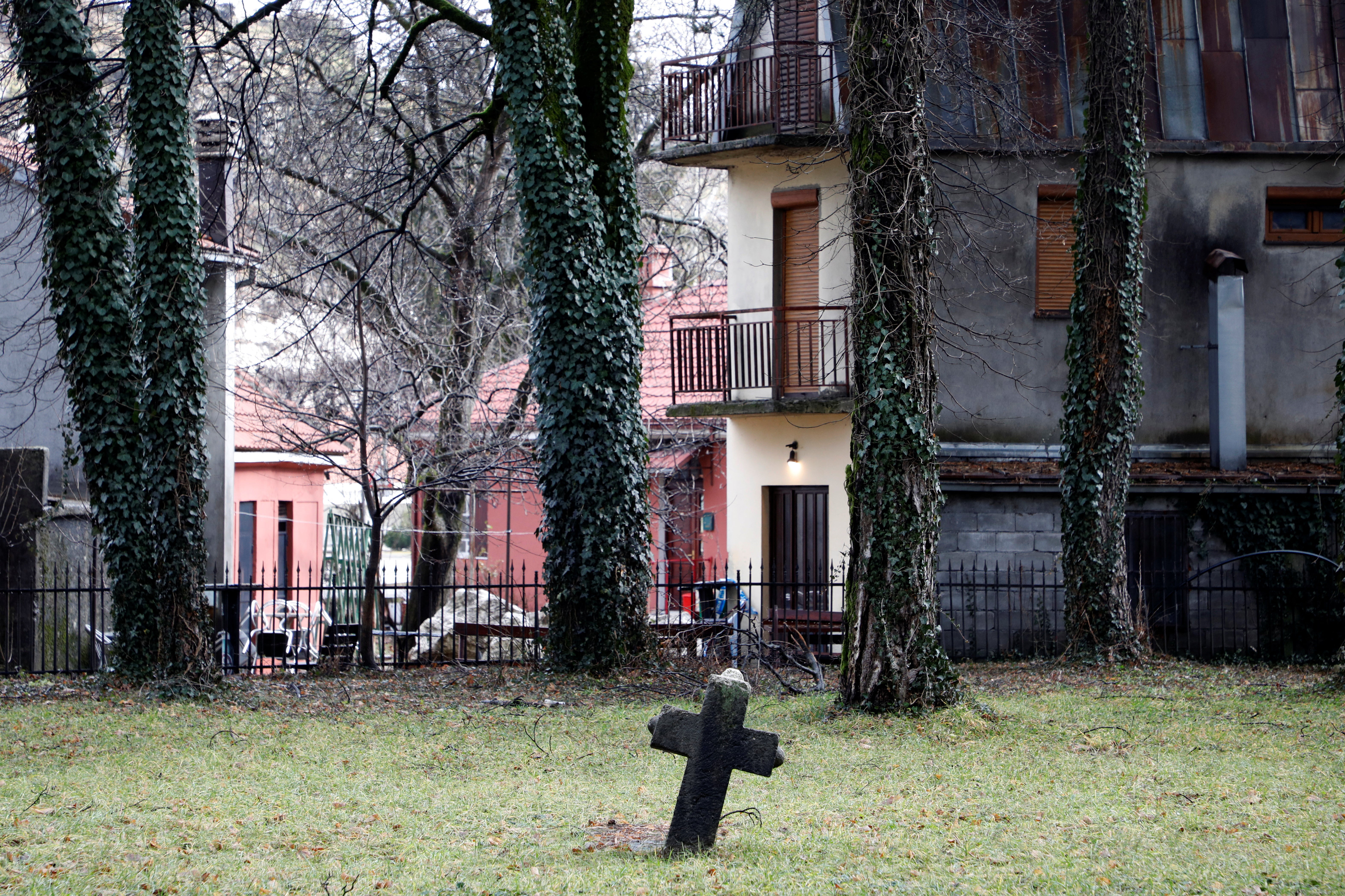 Old tombstone and church’s fence, made of 1544 barrels of muskets, stand next to a backdoor of the tavern where the January 1st killing spree started, in Cetinje, Montenegro, January 9, 2025