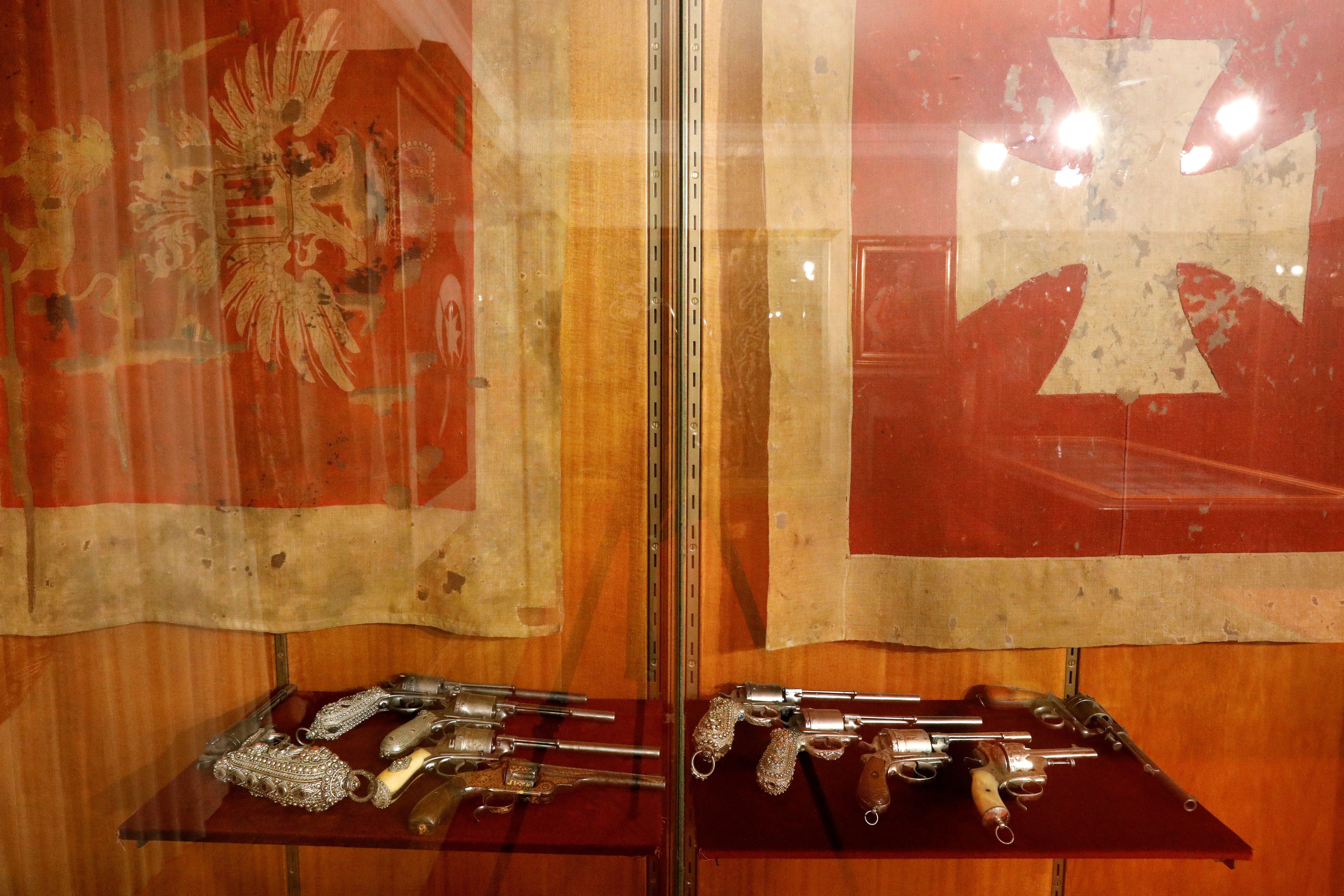 Lavishly decorated revolvers are seen under historical Montenegrin war flags in King Nikola Museum in Cetinje, Montenegro, January 9, 2025. REUTERS/Stevo Vasiljevic