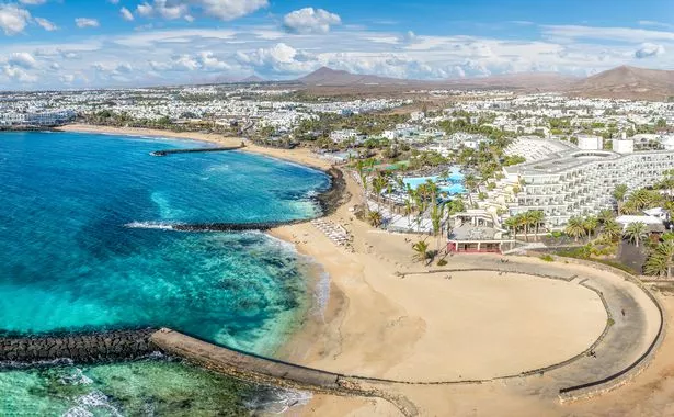 Playa de las Cucharas, Costa Teguise, Lanzarote: A perfect family beach with golden sand, turquoise waters, and a variety of water sports