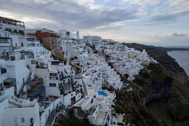 A photo shows a view of the town of Fira on the Greek Island of Santorini,