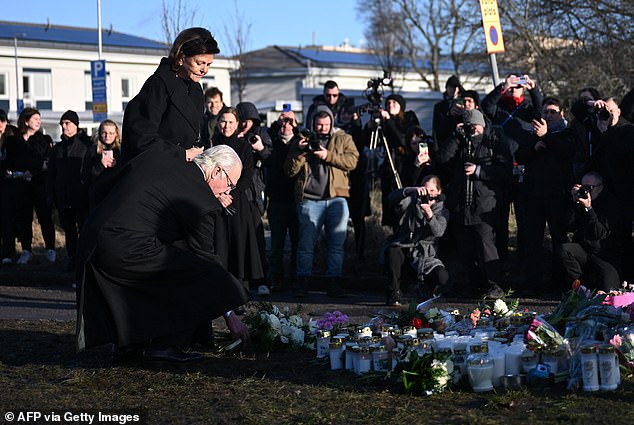 King Carl XVI Gustaf of Sweden (2n L) and Sweden's Queen Silvia (L) lay flowers the memorial outside the adult education center Campus Risbergska school in Orebro, Sweden, on February 5