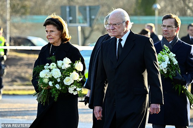 Sweden's King Carl Gustaf and Queen Silvia, Prime Minister Ulf Kristersson with his wife Birgitta Ed visit the memorial site where mourners placed candles and flowers outside Campus Risbergska School, the day after the school shooting at Risbergska school in Orebro, Sweden