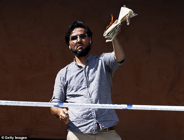 Anti-Islamist activist Salwan Momika burns a koran and covers it with bacon at the Stockholm mosque on June 28, 2023 in Stockholm, Sweden. He was shot dead last week