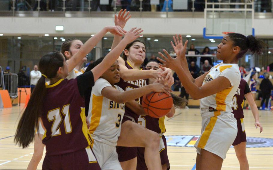 A horde of players tries to grab a rebound.