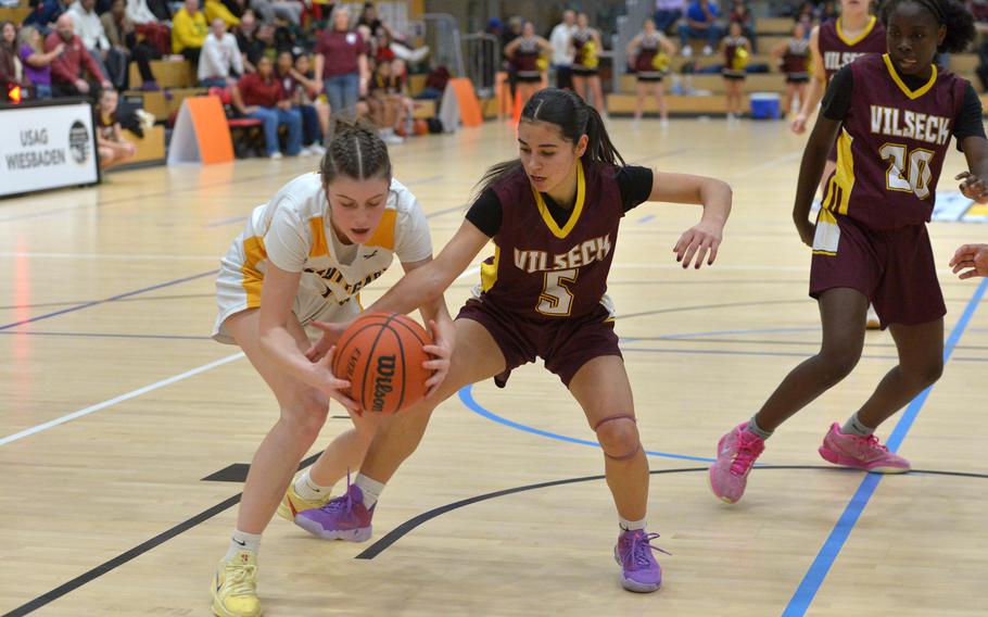 Hannah Holmes and Jayslin Santellano fight for the ball.