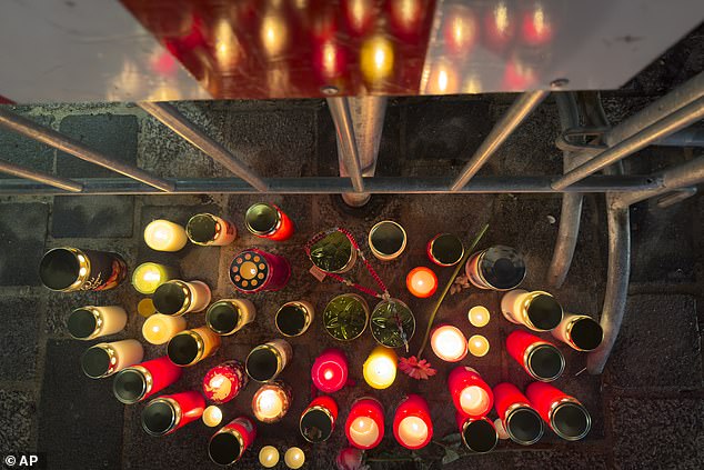 Candles have been lit at the site of the stabbing attack in Villach, Austria