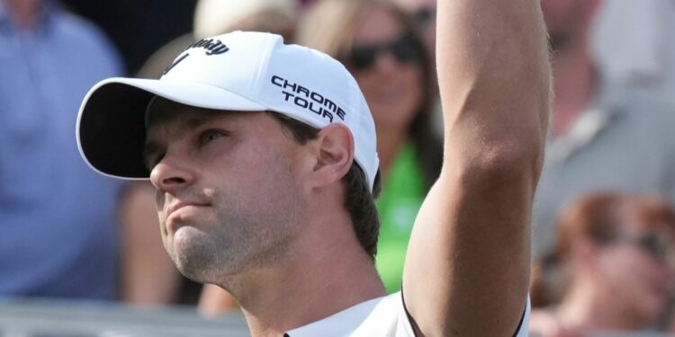 Thomas Detry, of Belgium, waves to the cheering crowd after hitting his tee shot close to the pin on the 16th hole during the final round of the Phoenix Open golf tournament at TPC Scottsdale, Sunday, Feb. 9, 2025, in Scottsdale, Ariz. (AP Photo/Ross D. Franklin)