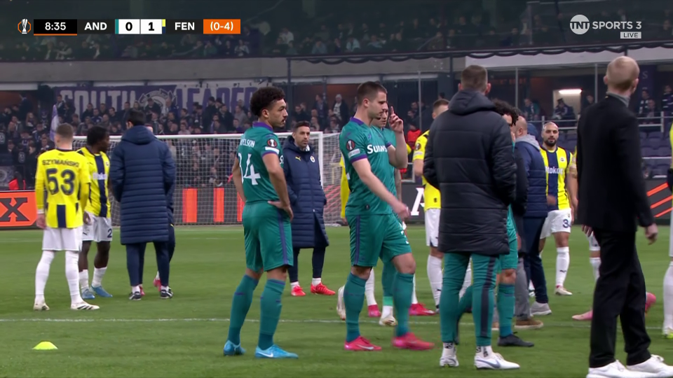 Soccer players on the field after a game.