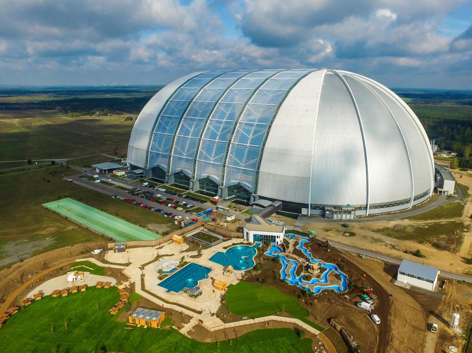 Aerial view of Tropical Islands in Krausnick, Germany, showing the new outdoor water park with its large dome and winding lazy river.