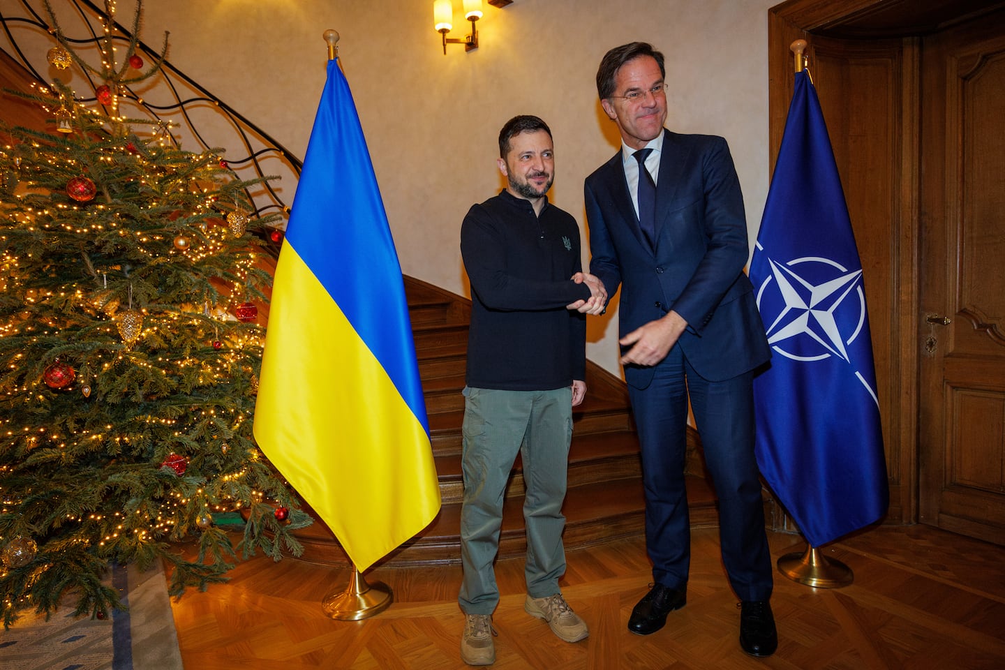 NATO Secretary General Mark Rutte, right, shakes hands with Ukraine's President Zelenskyy prior to a meeting in Brussels on Dec. 18.